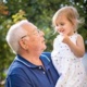 Grandfather holding granddaughter, after seeking out help with grandparents rights.
