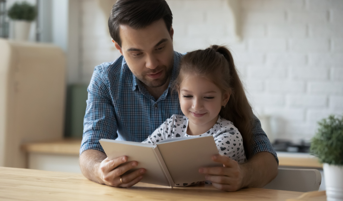 Caring Caucasian Father With 9s Daughter Reading Book Together